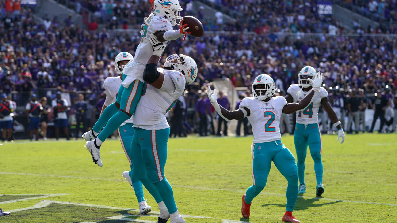 Dolphins players celebrate after a TD