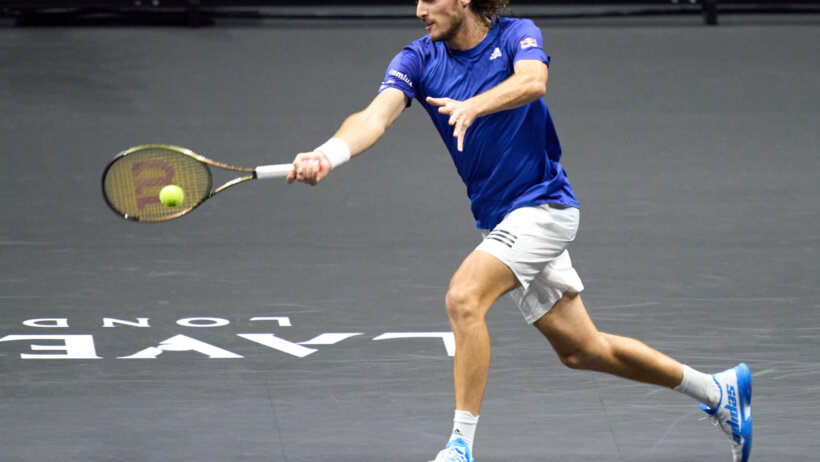 Stefanos Tsitsipas hitting a forehand shot during a tennis match.