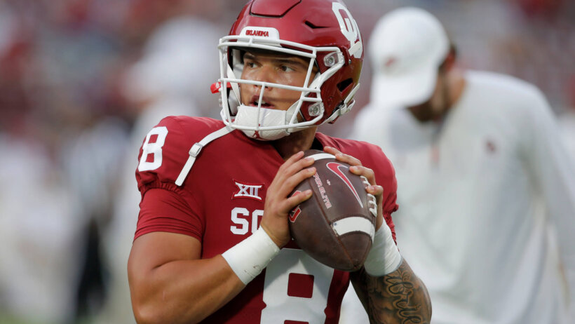 Dillon Gabriel dropping back to throw football