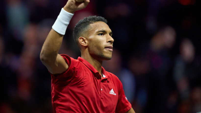 Felix Auger-Aliassime celebrating with his fist in the air.