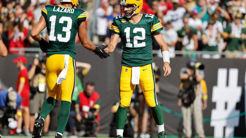 Allen Lazard shakes hands with Aaron Rodgers