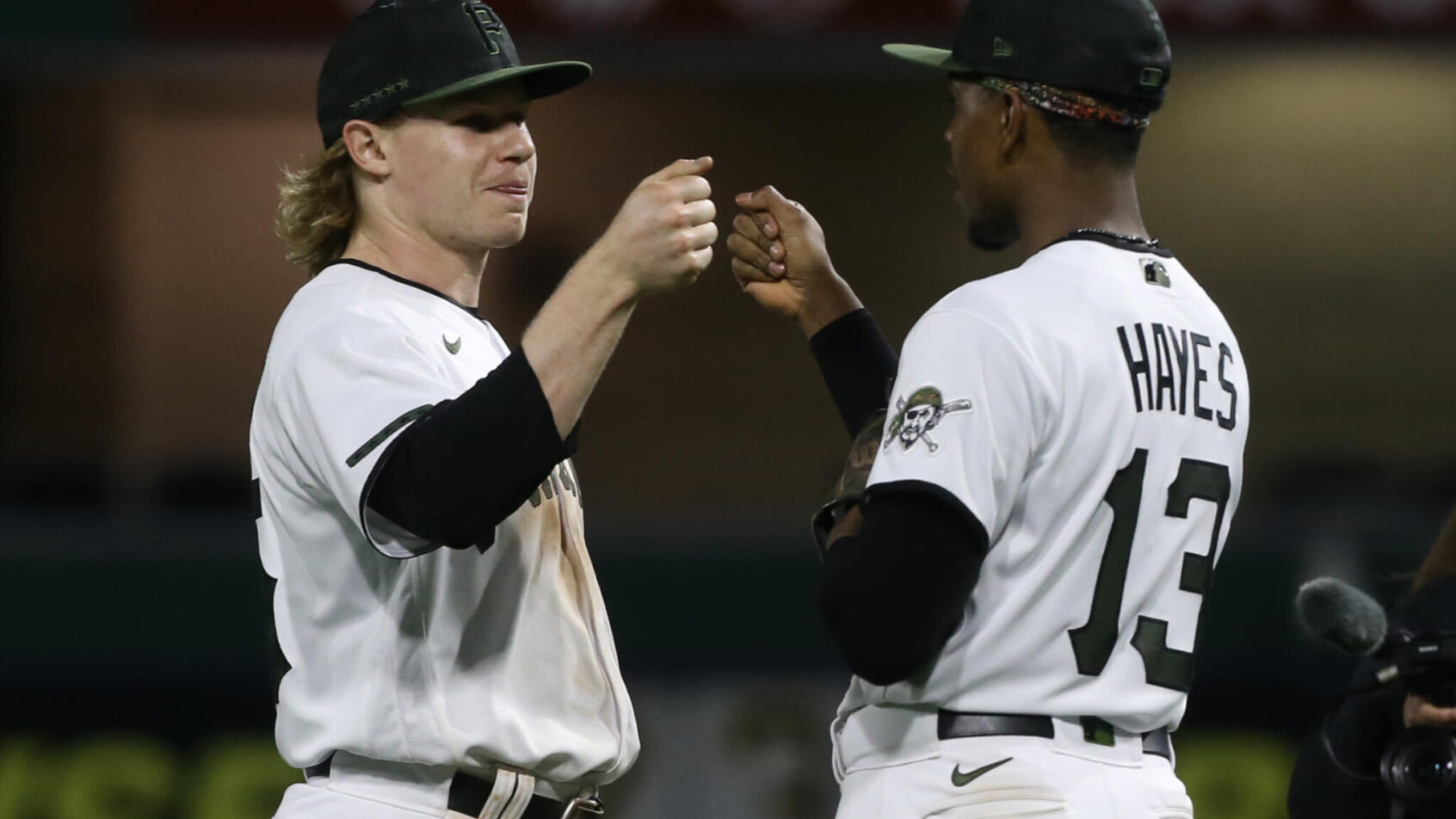 Pittsburgh Pirates left fielder Jack Suwinski and third baseman Ke'Bryan Hayes fist bumping