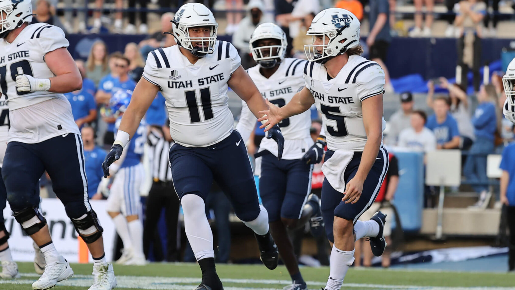 Utah State players celebrating after a touchdown.