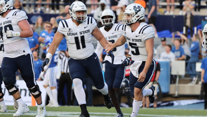 Utah State players celebrating after a touchdown.
