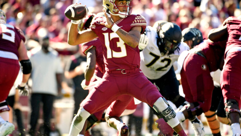 Florida State Seminoles quarterback Jordan Travis looks to throw