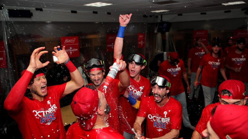 Phillies players celebrate making the 2022 MLB playoffs