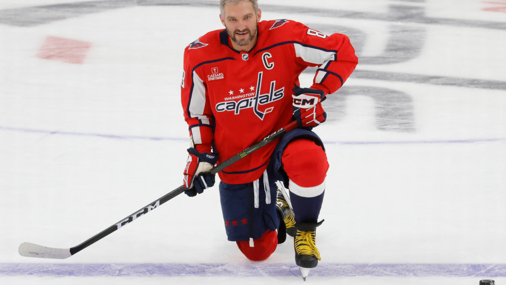 Washington Capitals left wing Alex Ovechkin kneels on ice