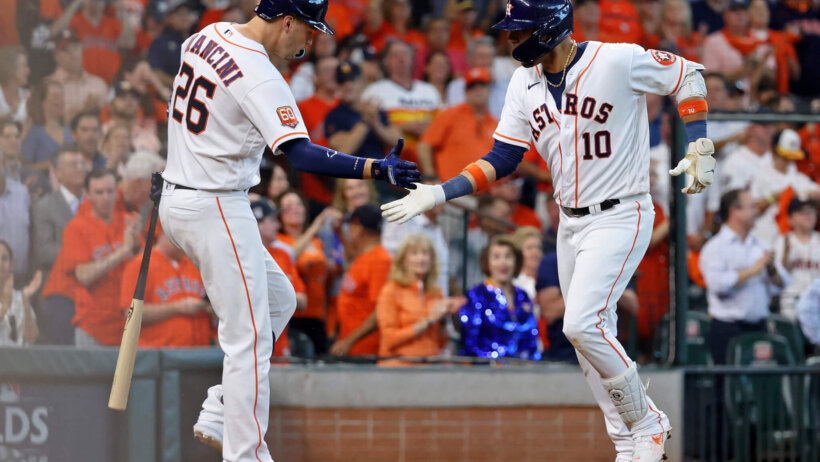 Houston Astros first baseman Yuli Gurriel high-fives designated hitter Trey Mancini