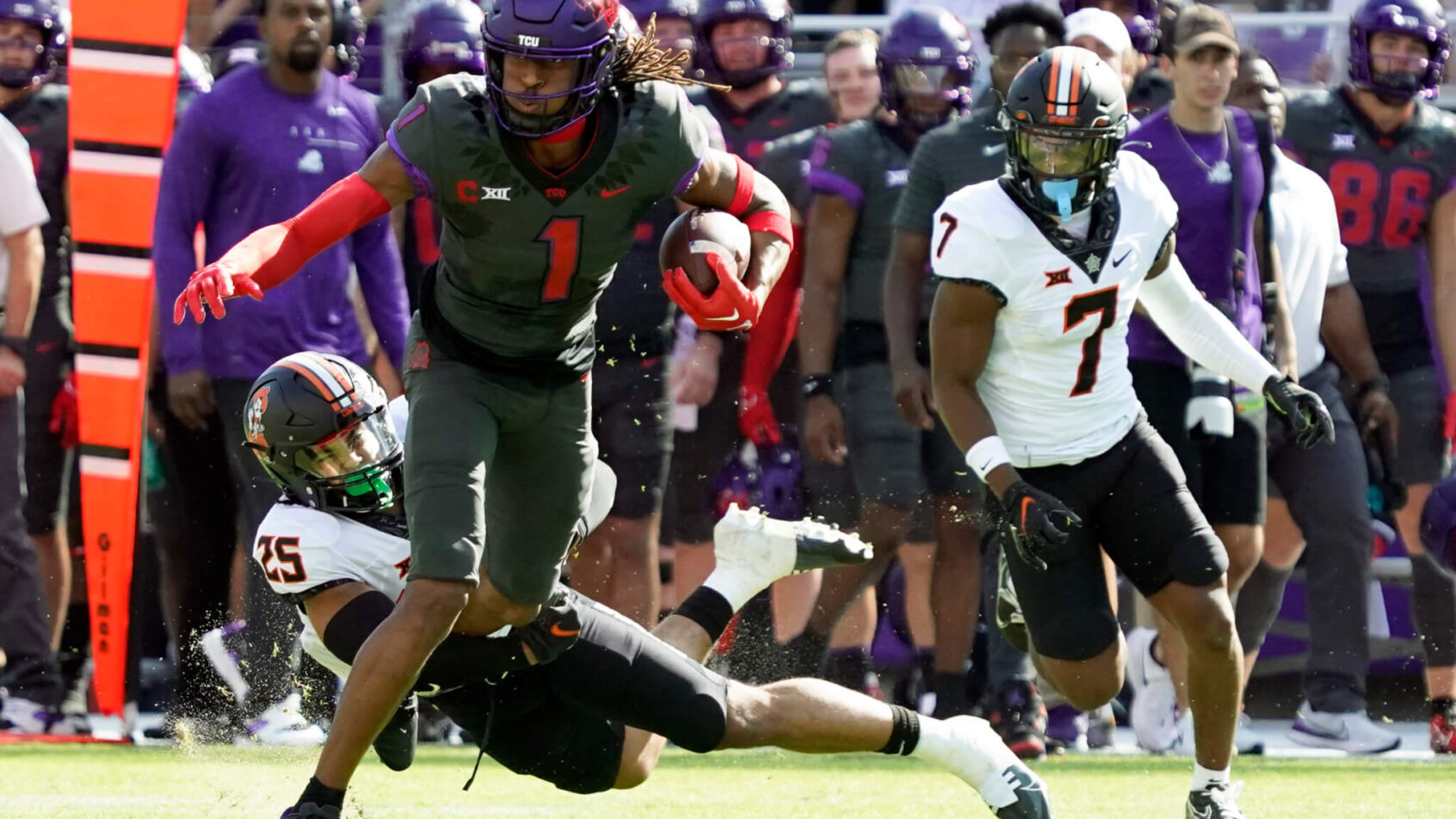 TCU Horned Frogs wide receiver Quentin Johnston is tackled by Oklahoma State Cowboys safety Jason Taylor