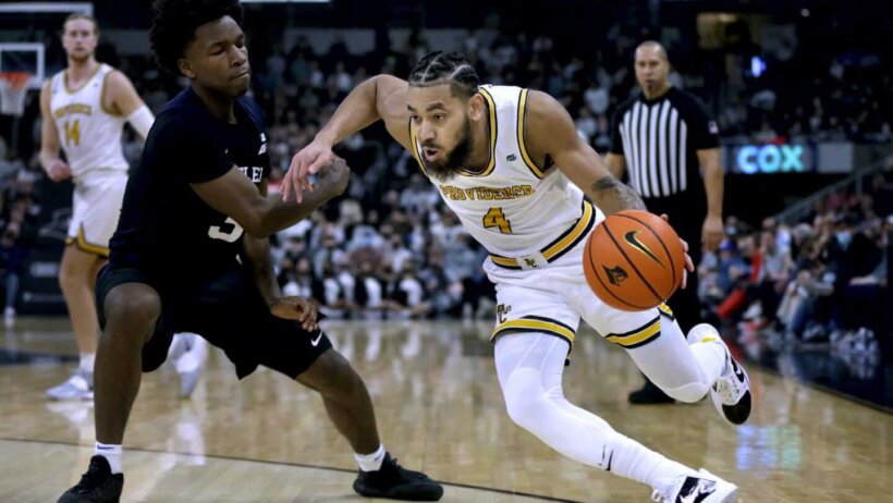 Providence guard Jared Bynum drives around a defender