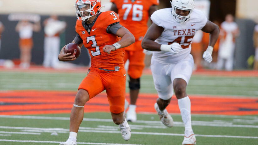 Oklahoma State Cowboys quarterback Spencer Sanders scrambles