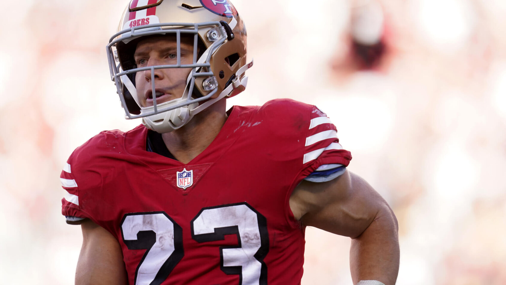 San Francisco 49ers running back Christian McCaffrey jogs towards the sideline after a play