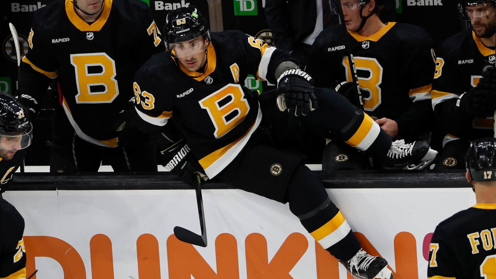 Boston Bruins left wing Brad Marchand hops the boards for a shift