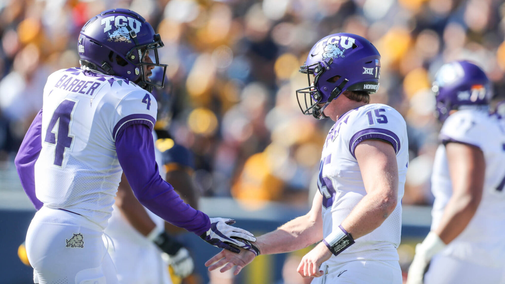 TCU quarterback Max Duggan congratulates his receiver