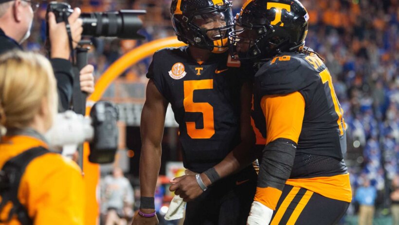 Tennessee quarterback Hendon Hooker celebrates with offensive lineman Javontez Spraggins