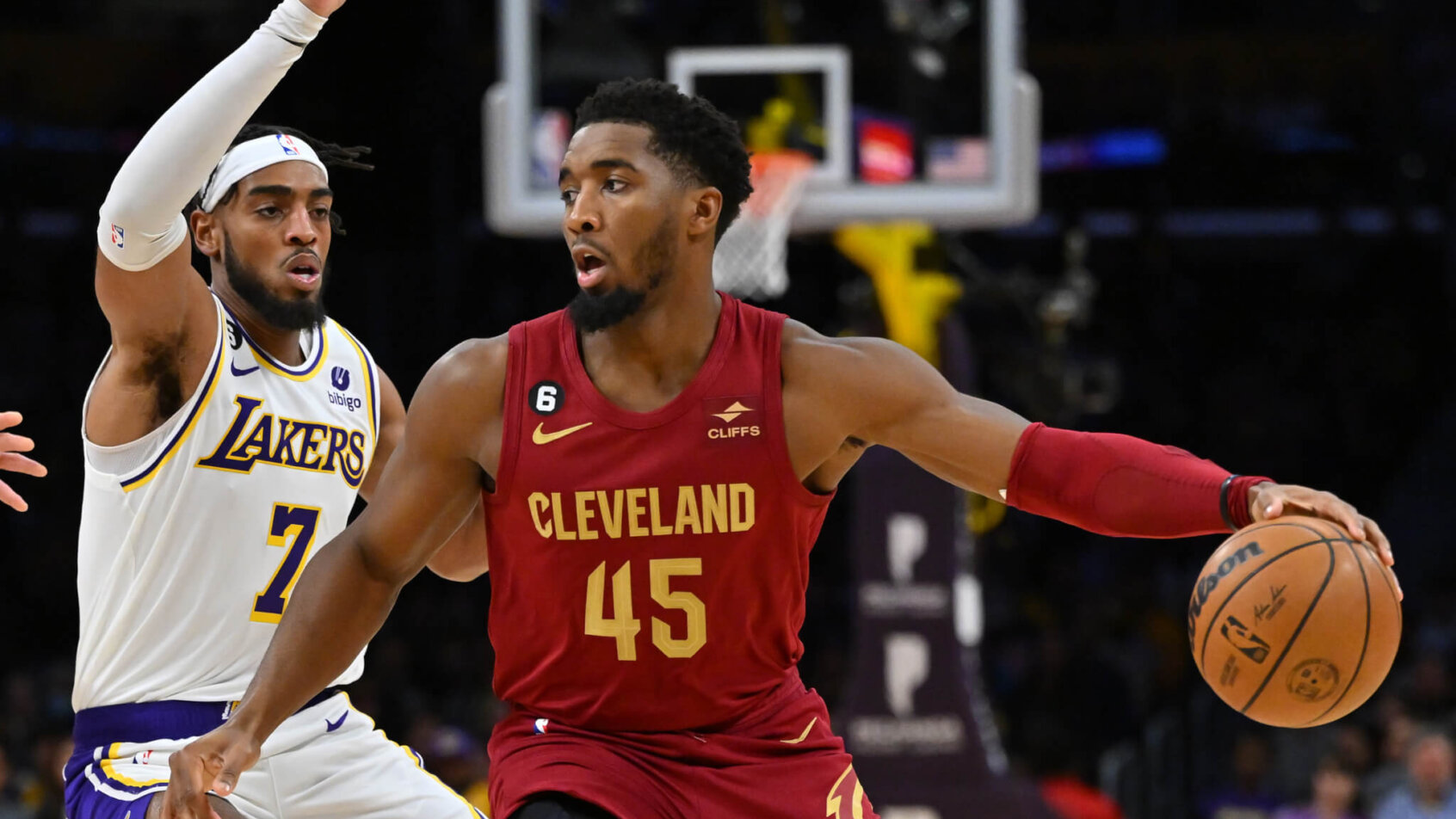 Donovan Mitchell dribbling with defender on his back