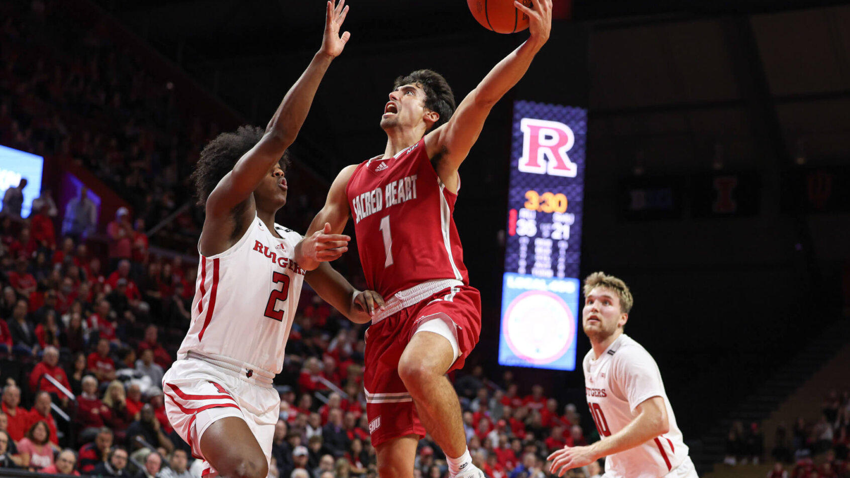 Sacred Heart Pioneers guard Joey Reilly holds off a defender while going for a layup