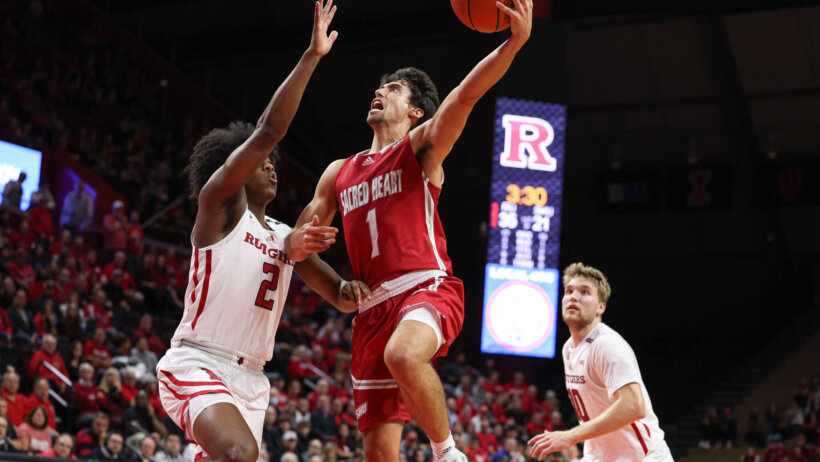 Sacred Heart Pioneers guard Joey Reilly holds off a defender while going for a layup