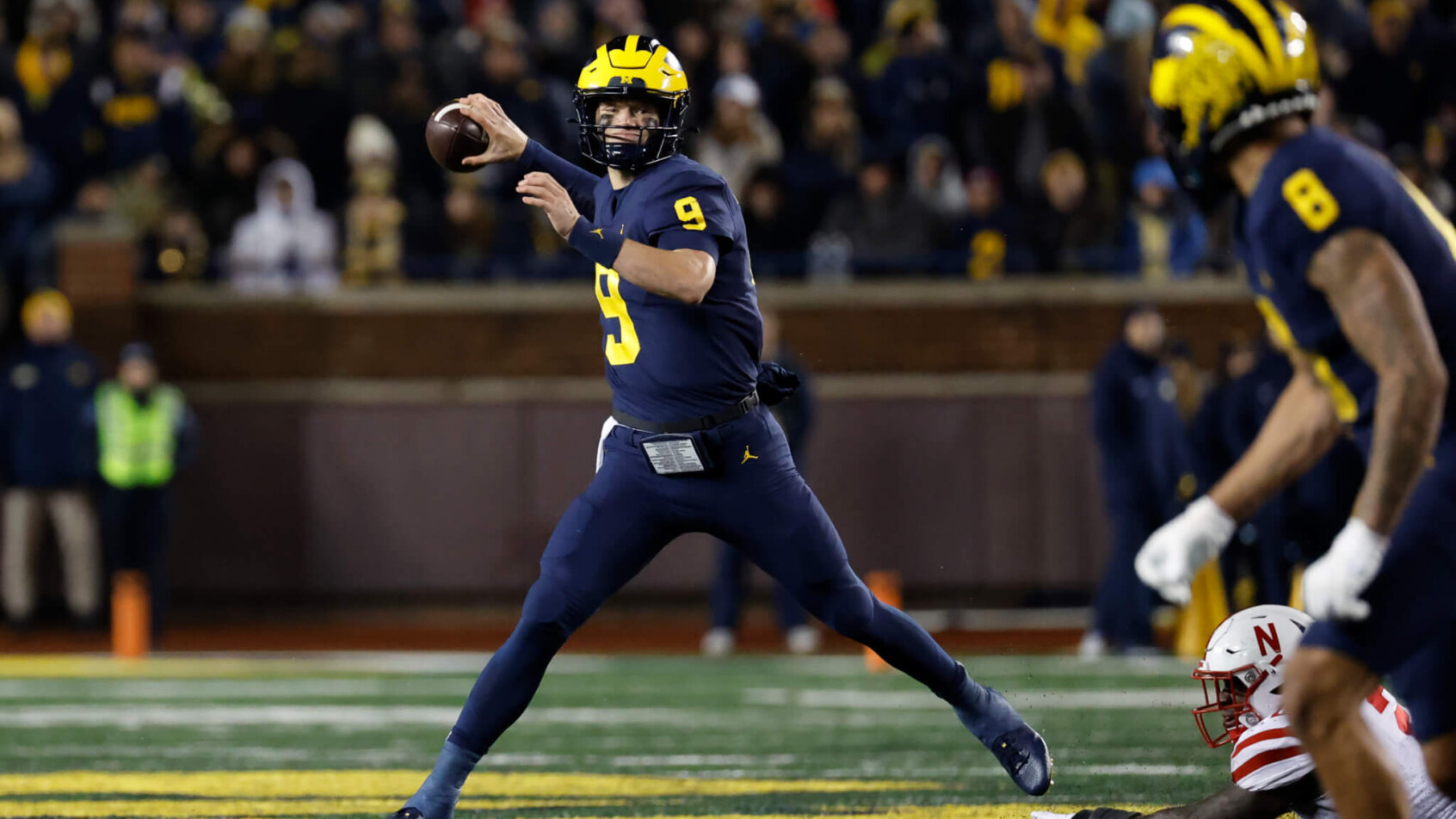 J.J. McCarthy rolls out to throw