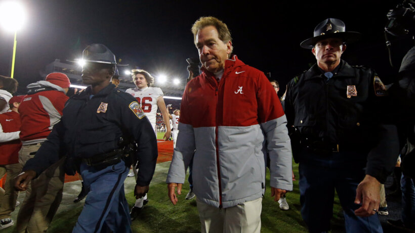 Nick Saban walks off the field
