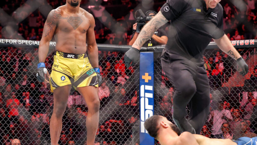 Dominick Reyes watches Ryan Spann on the mat after a knockdown