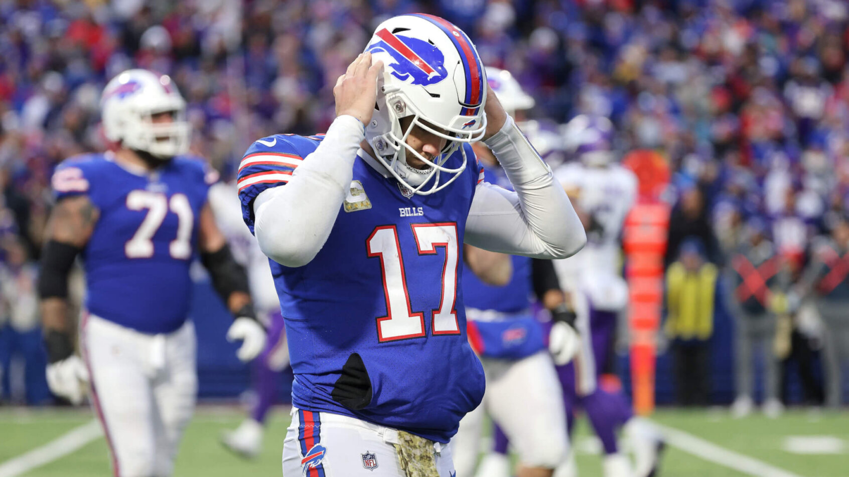 Josh Allen hands on helmet