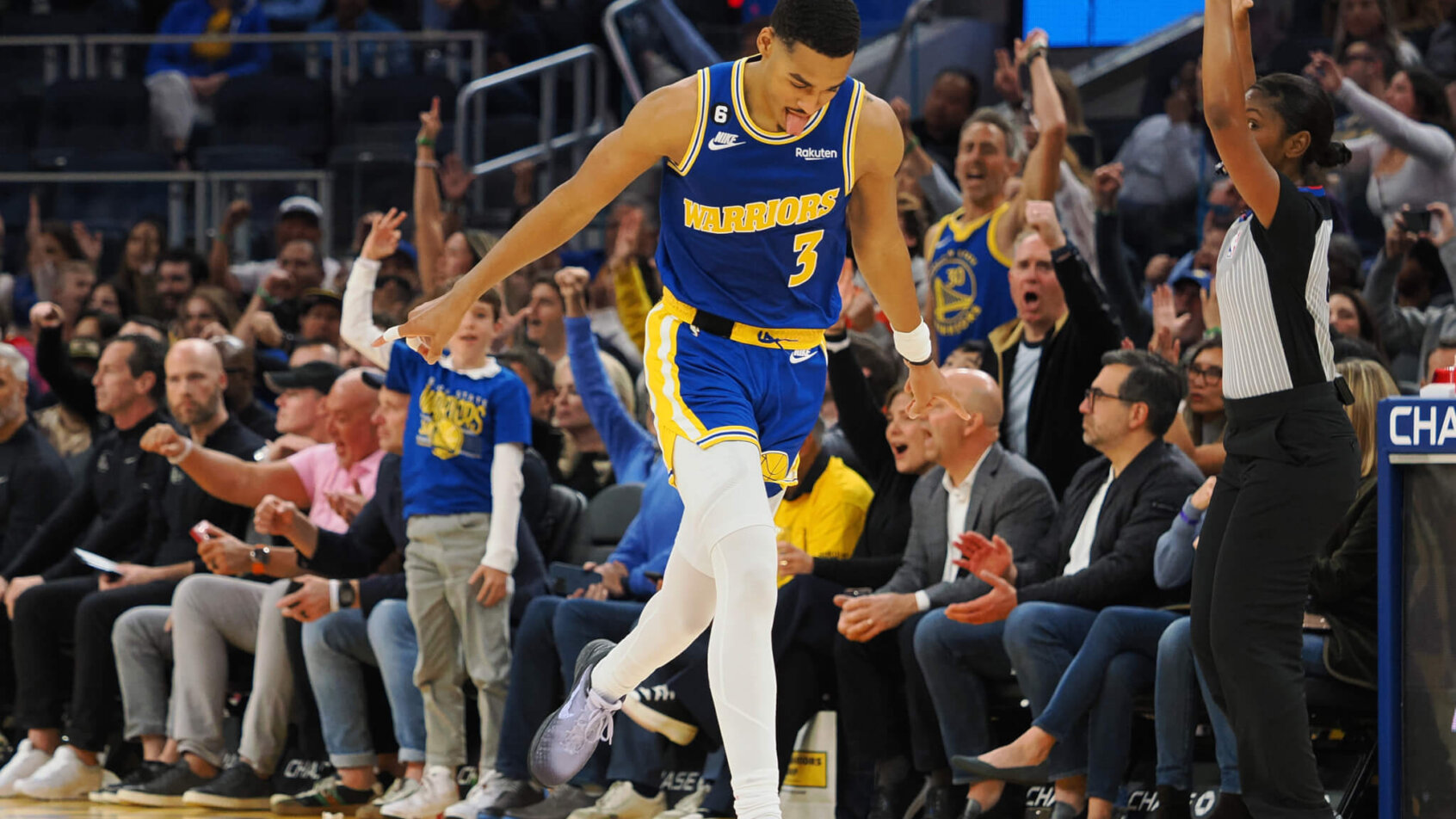 Jordan Poole reacts after hitting 3.
