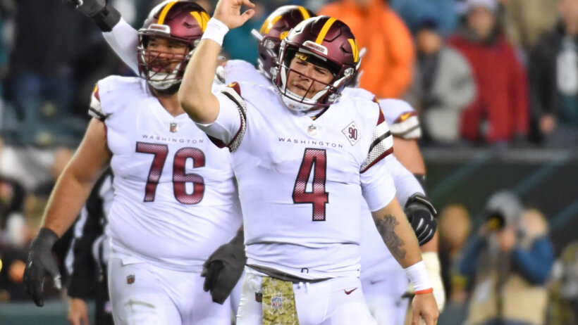 Washington Commanders quarterback Taylor Heinicke celebrates a penalty