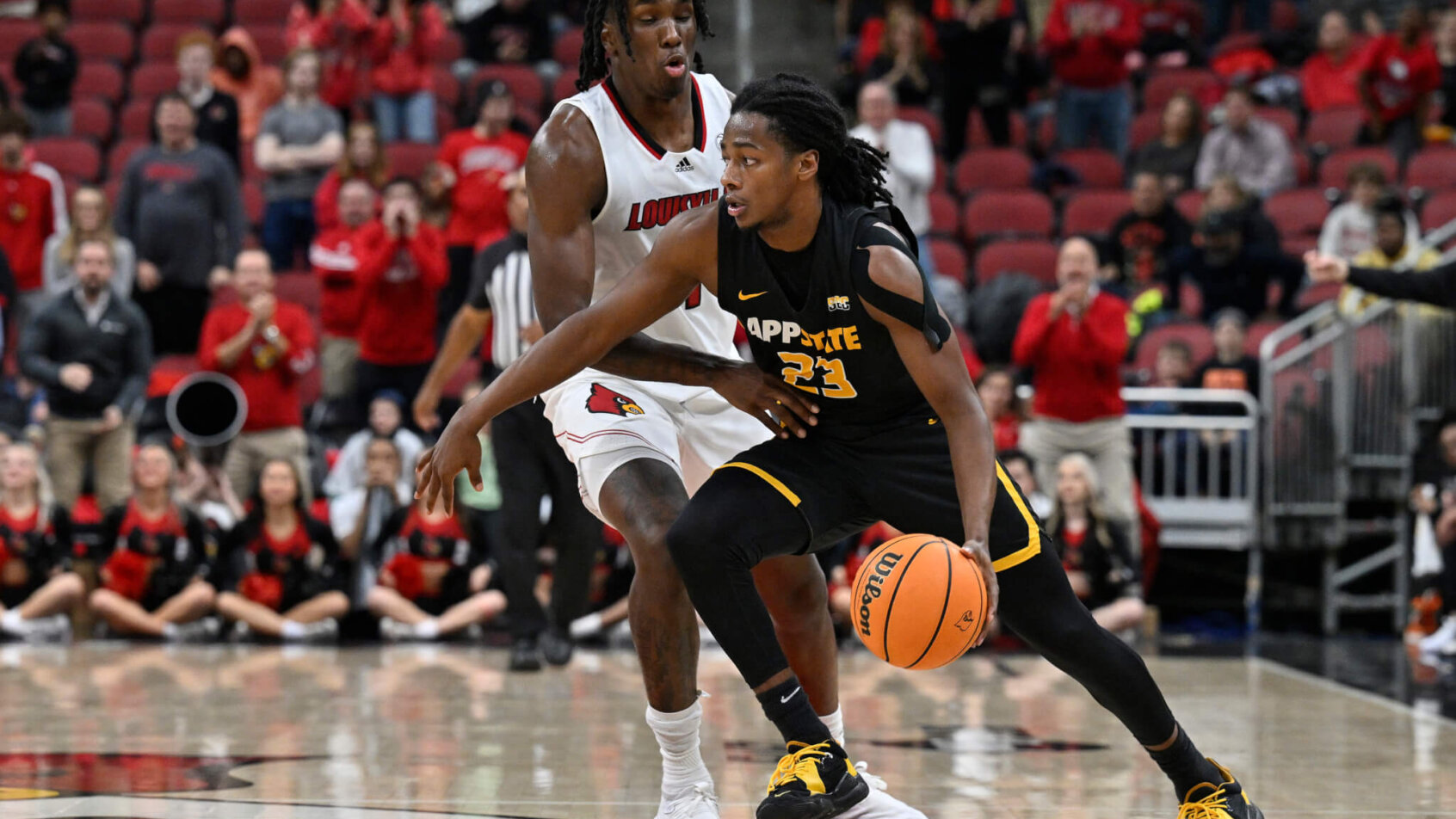 Appalachian State Mountaineers guard Terence Harcum holds off a defender