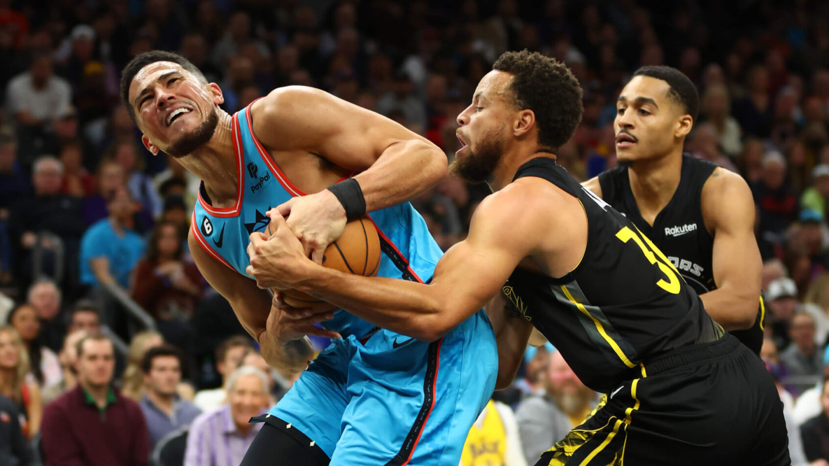 Devin Booker and Steph Curry fighting for ball