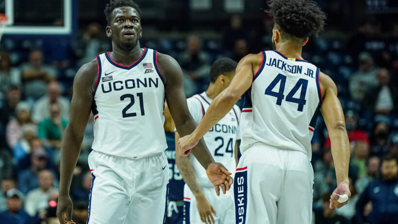 Connecticut Huskies forward Adama Sanogo and guard Andre Jackson Jr celebrating
