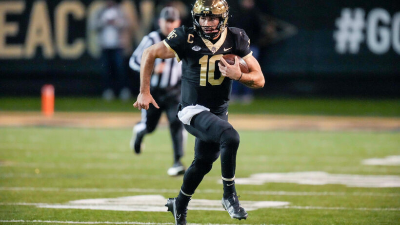 Wake Forest Demon Deacons quarterback Sam Hartman runs the ball
