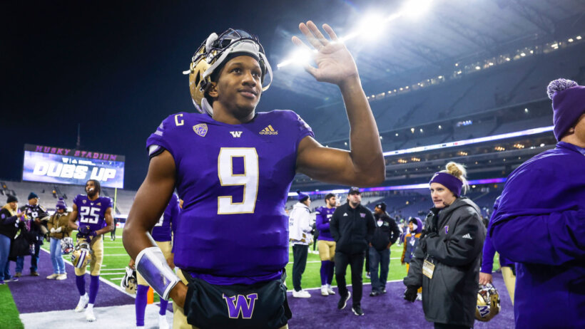 Michael Penix Jr. waves to the crowd after a game.