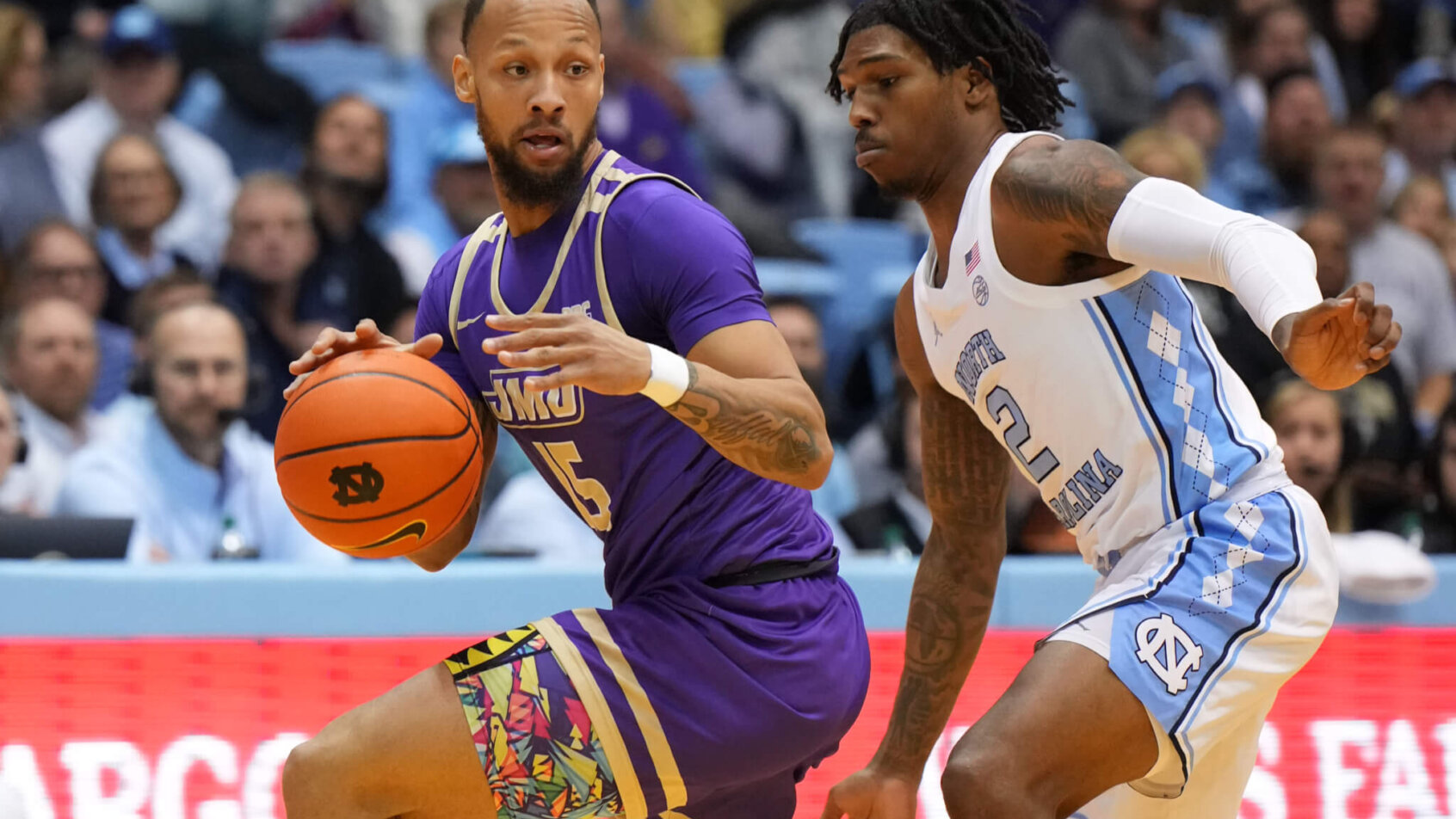 Takal Molson is guarded closely by Caleb Love