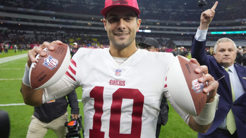 Jimmy Garoppolo holding footballs