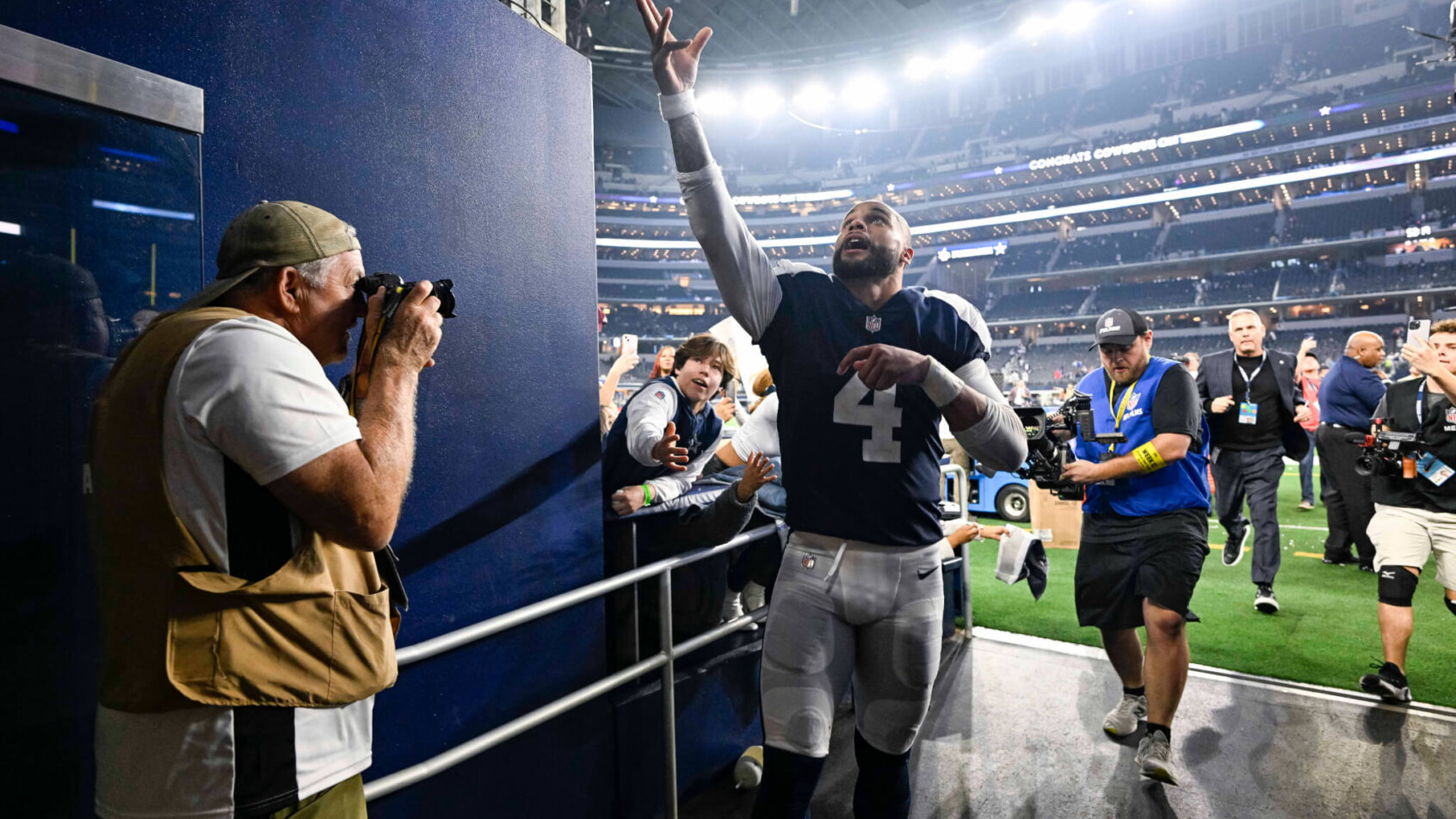 Dak Prescott gives a souvenir to a fan