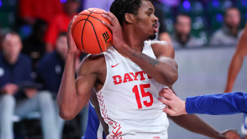 Daron Holmes II holding basketball away from defender