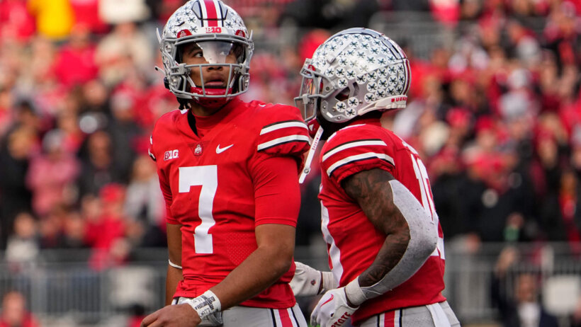 Ohio State Buckeyes C.J. Stroud looking up at scoreboard red jersey