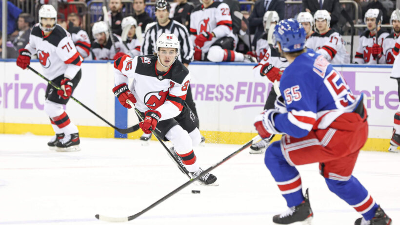 New Jersey Devils center Jack Hughes carries the puck during the first period