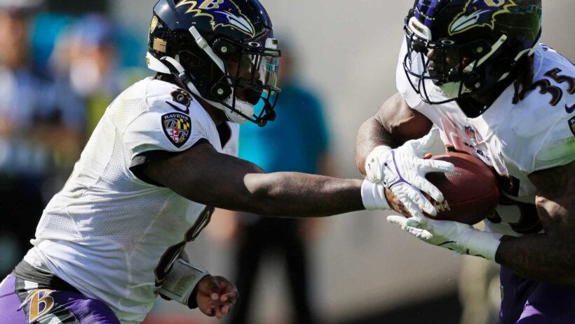 Baltimore Ravens players Lamar Jackson and Gus Edwards