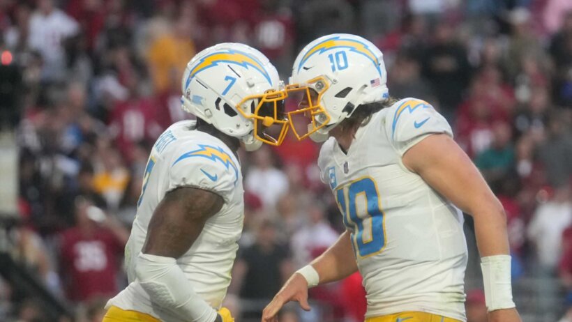 Los Angeles Chargers quarterback Justin Herbert celebrates with tight end Gerald Everett