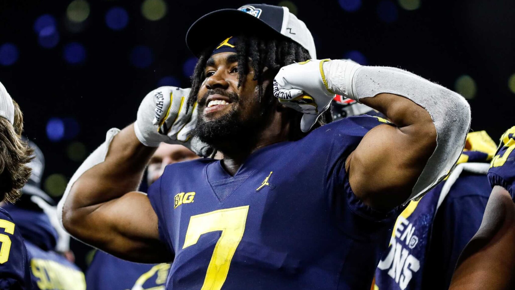 Michigan running back Donovan Edwards flexes after a win