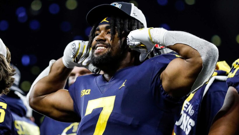 Michigan running back Donovan Edwards flexes after a win
