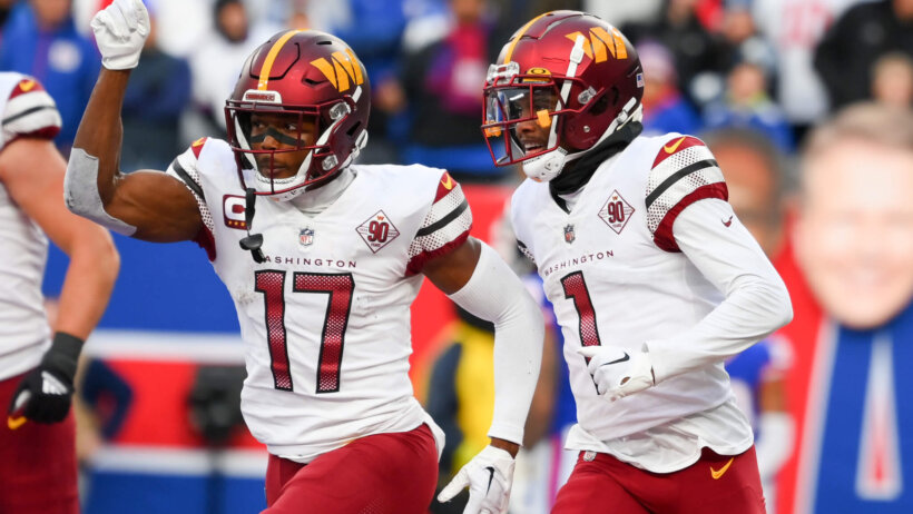 Terry McLaurin pointing skywards beside Jahan Dotson