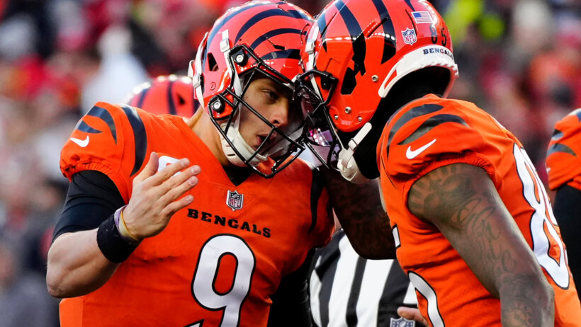 Joe Burrow bumps helmet with teammate