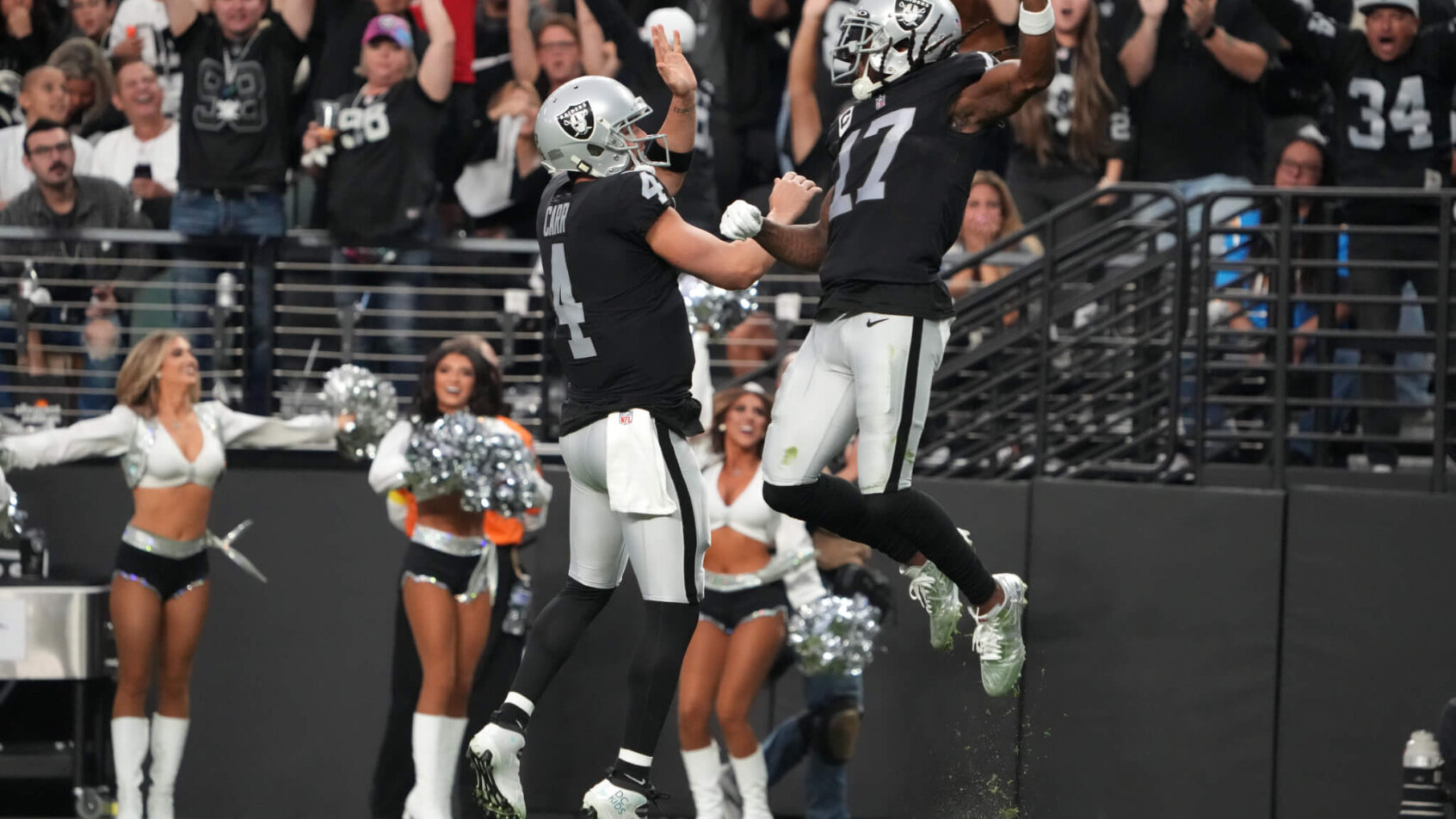 Las Vegas Raiders wide receiver Davante Adams celebrates with quarterback Derek Carr