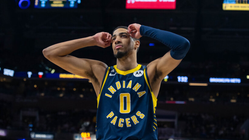 Tyrese Haliburton hands on temples of forehead