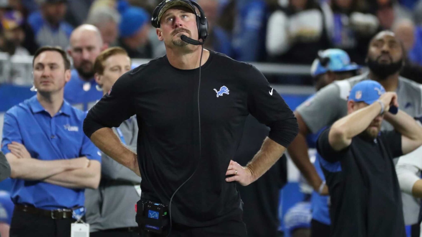 Dan Campbell looking up, hands on hips