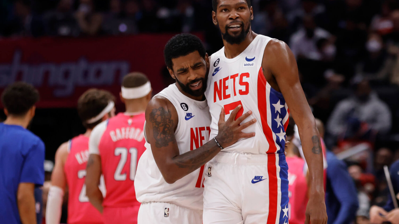Kyrie Irving and Kevin Durant hug on court