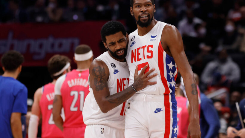 Kyrie Irving and Kevin Durant hug on court